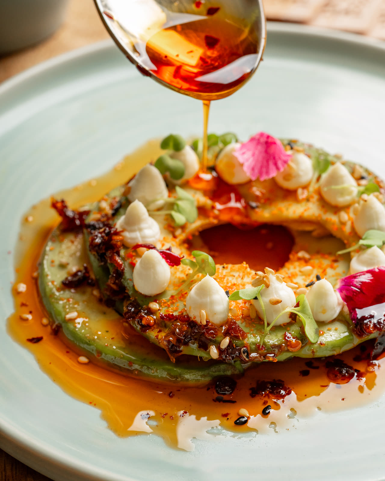 Avocado ring finished with chilli crisp